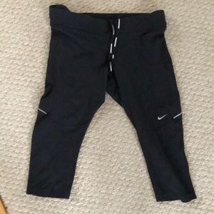 Nike brand size M black running capris.